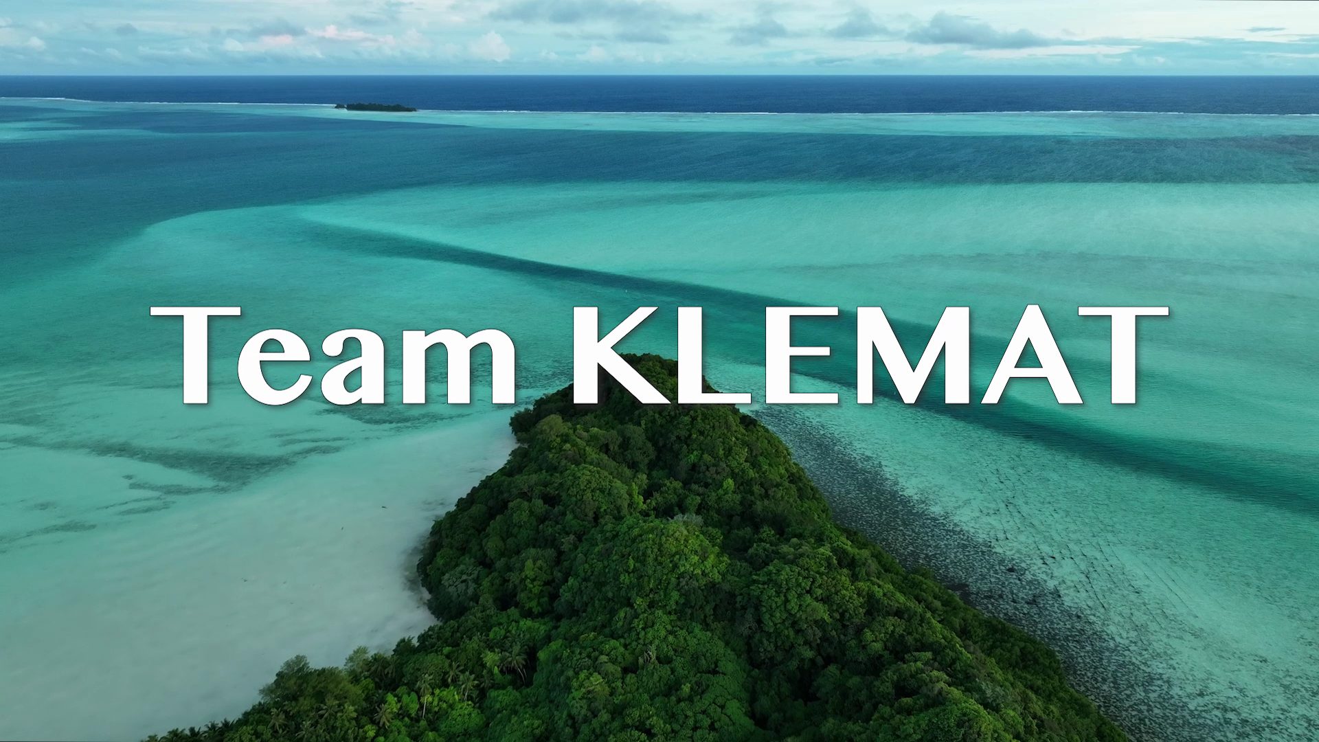 Aerial view of a turquoise lagoon and a forested island in Palau